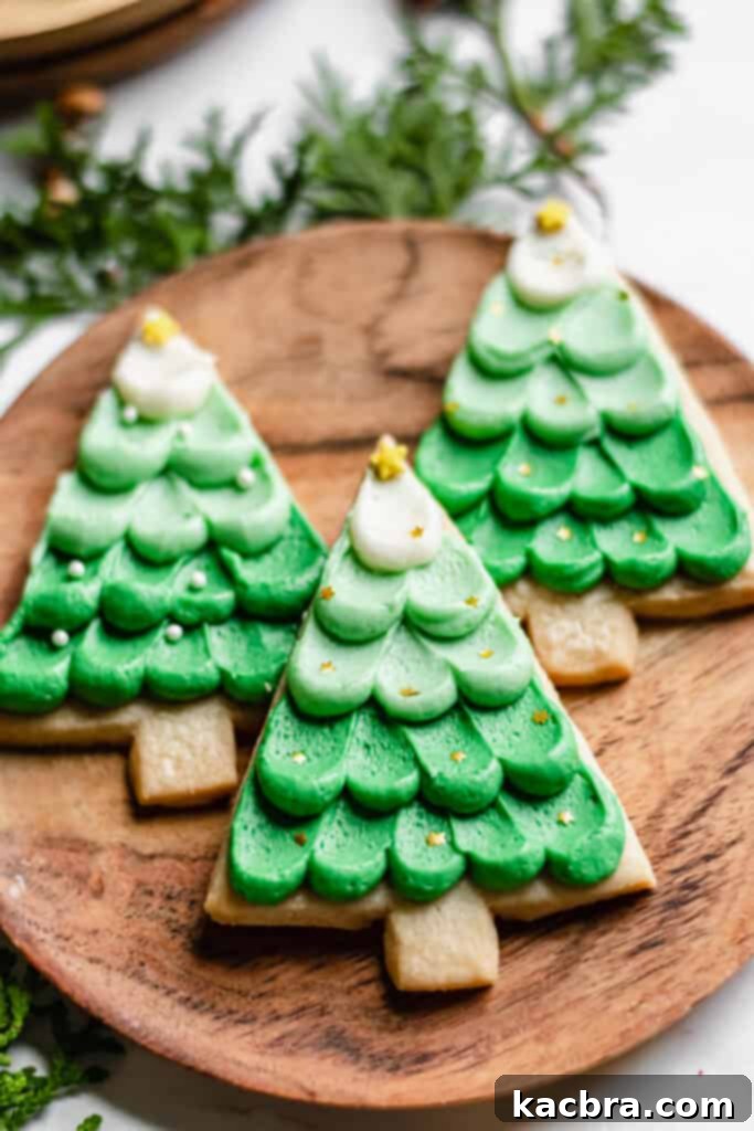 Three Christmas Shortbread Cookies on a wooden plate.