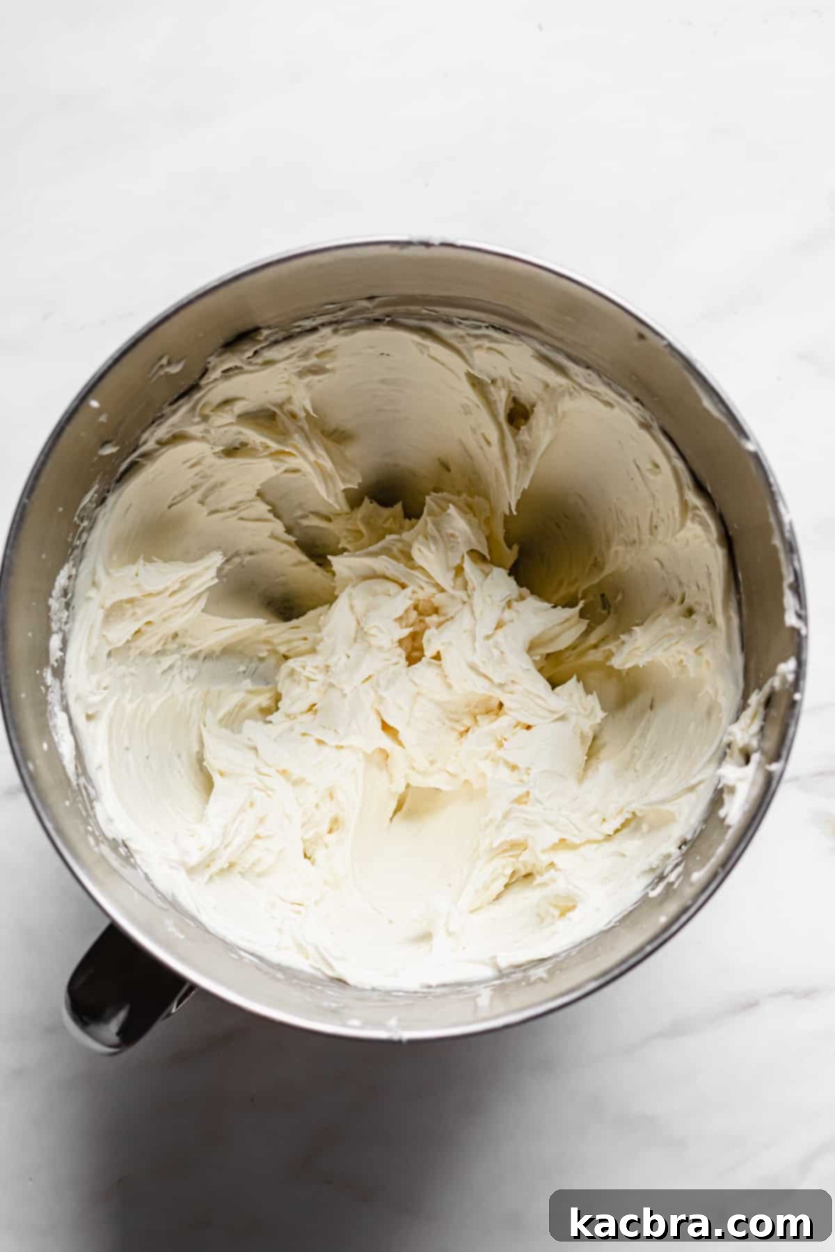 Fluffy, finished buttercream in the mixing bowl.
