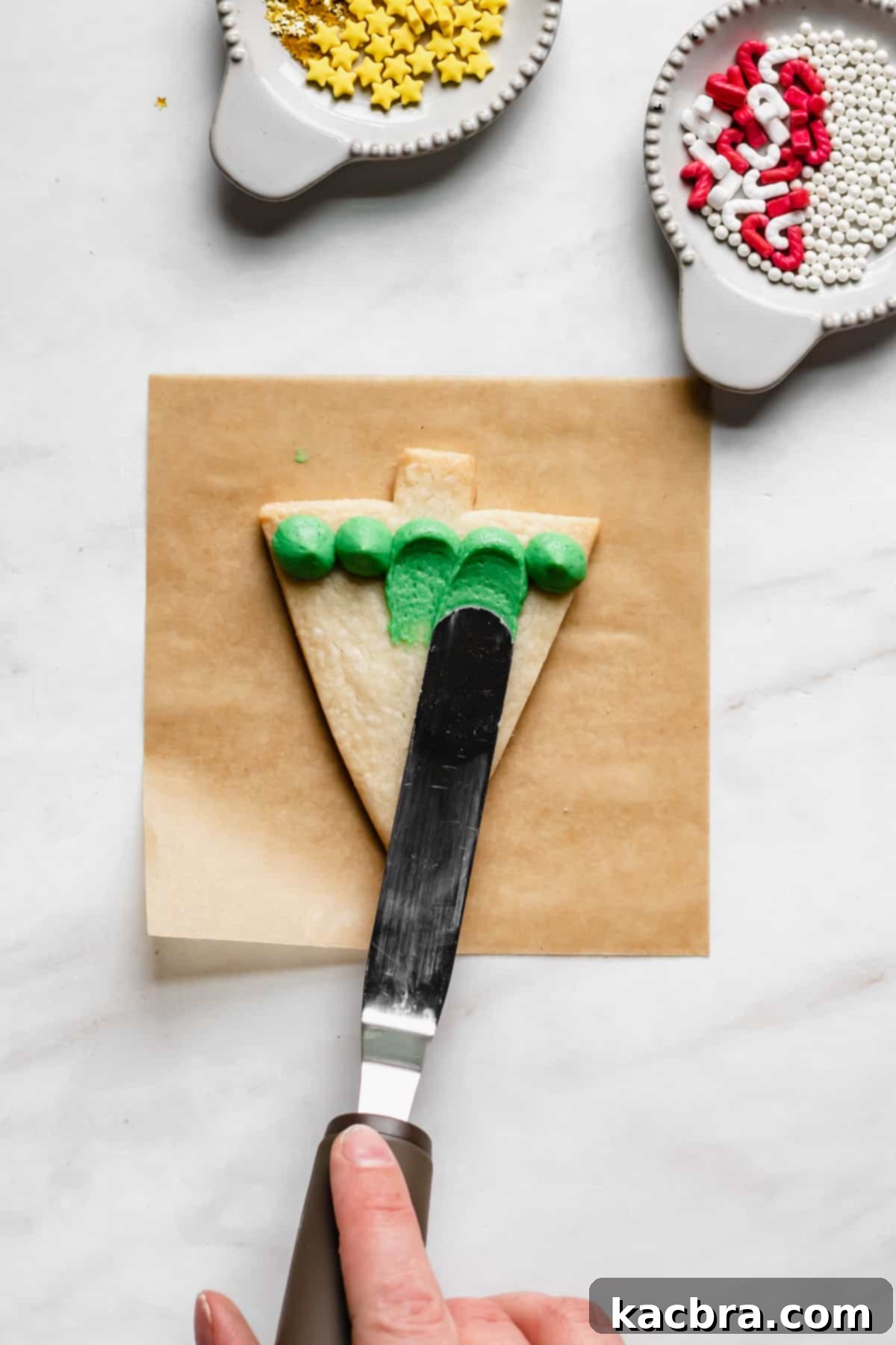 Offset spatula making the design in the icing.