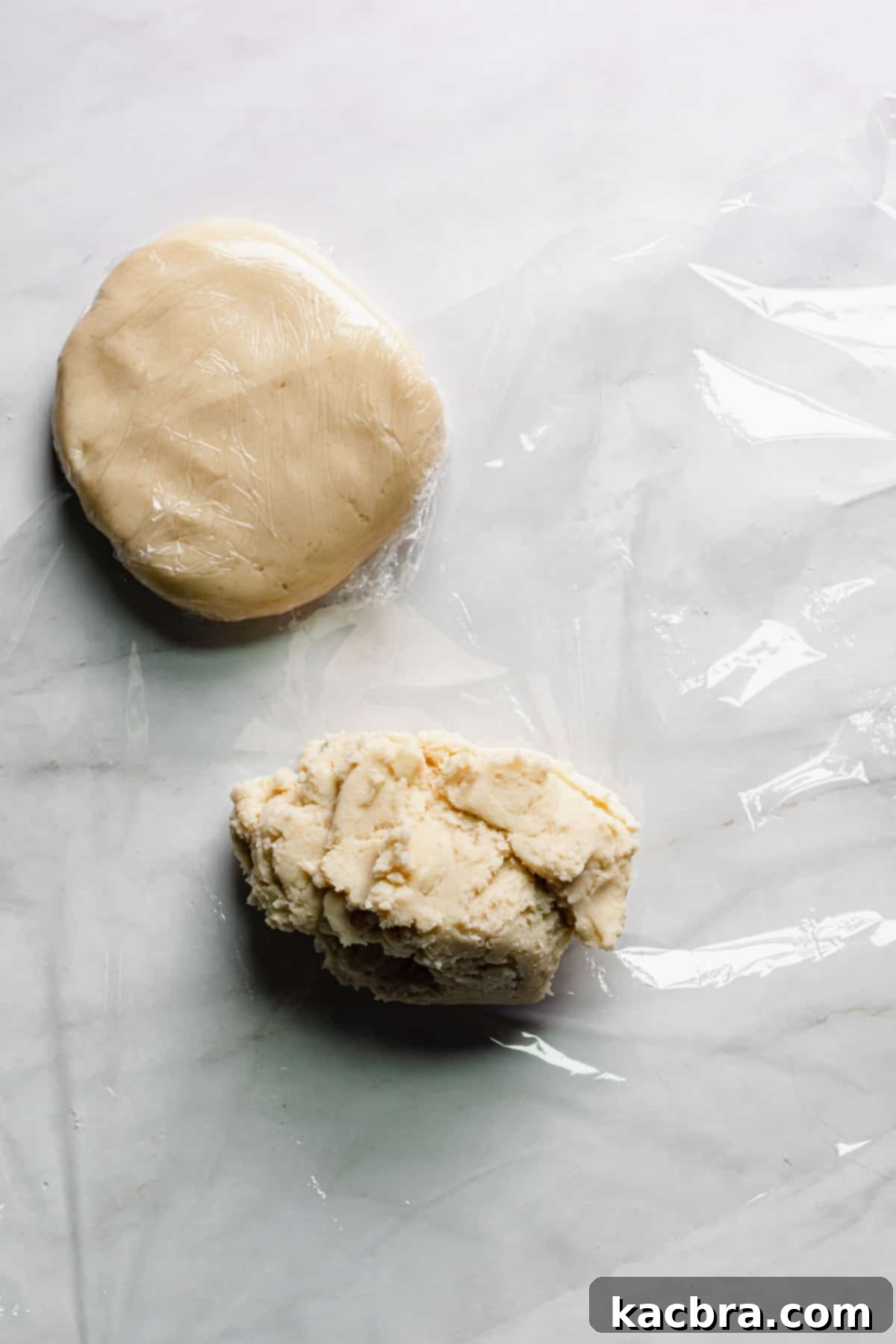 Dough being wrapped in plastic wrap.