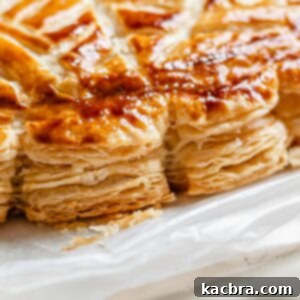 Flaky baked layers of rough puff pastry, golden brown and puffed.