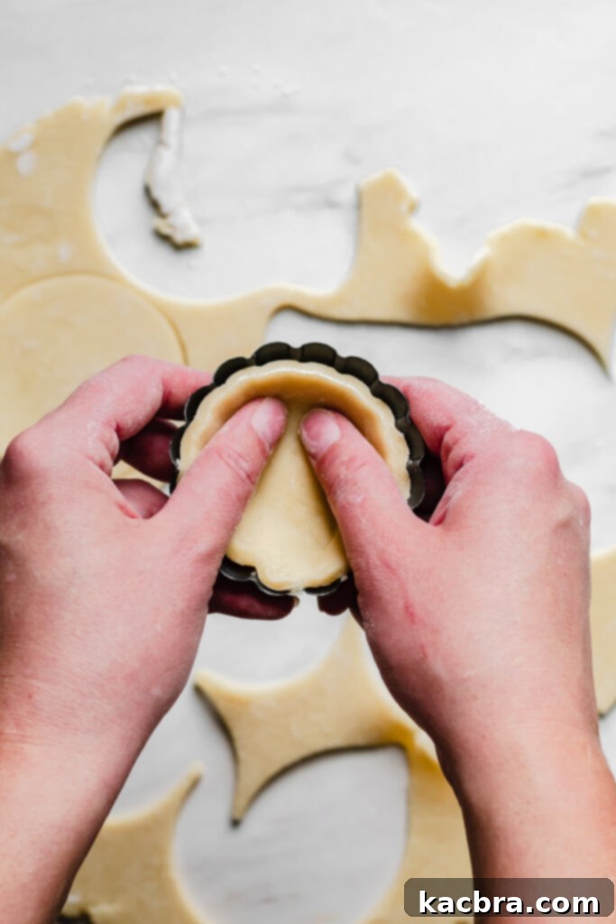Dough being pushed into a tartlet pan