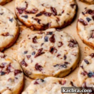 An array of baked slice and bake cookies on a pan, golden and inviting.