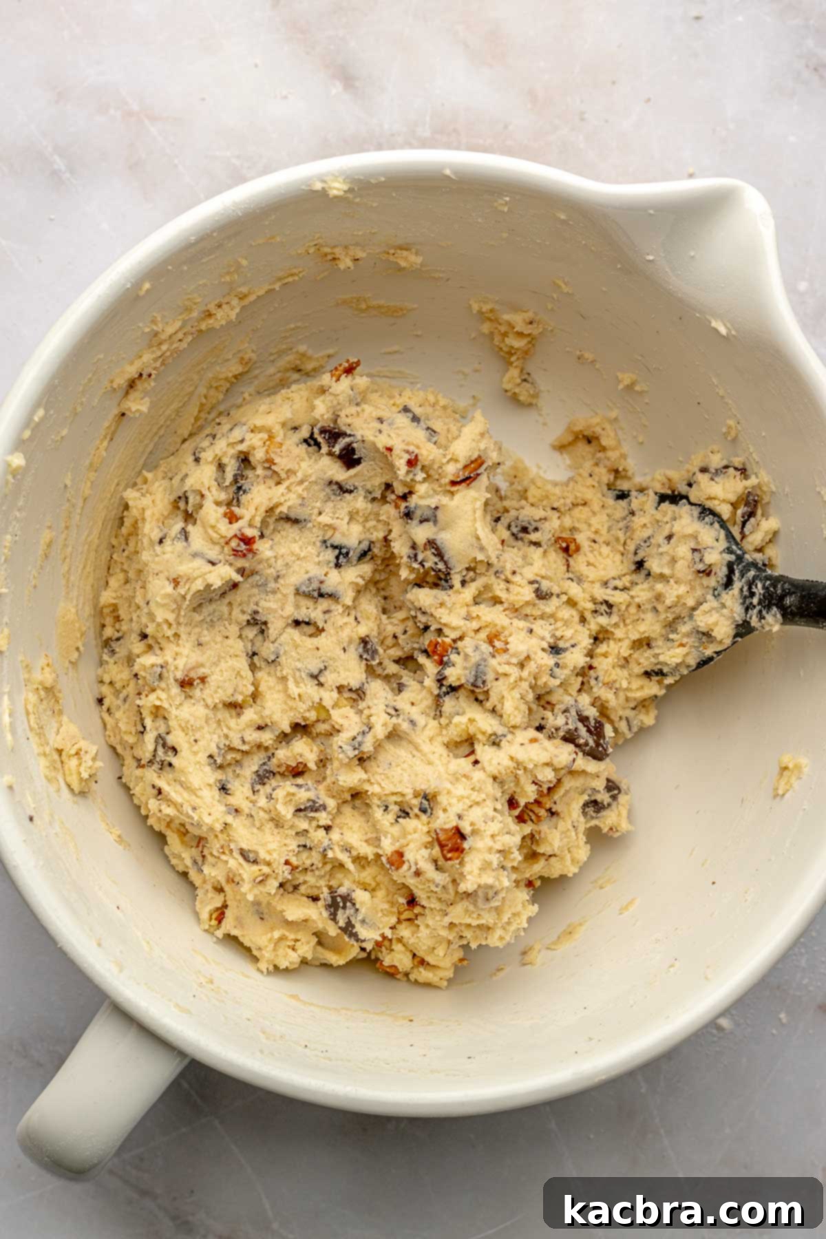 Shortbread cookie dough with chocolate, pecans, and dried cherries mixed in.