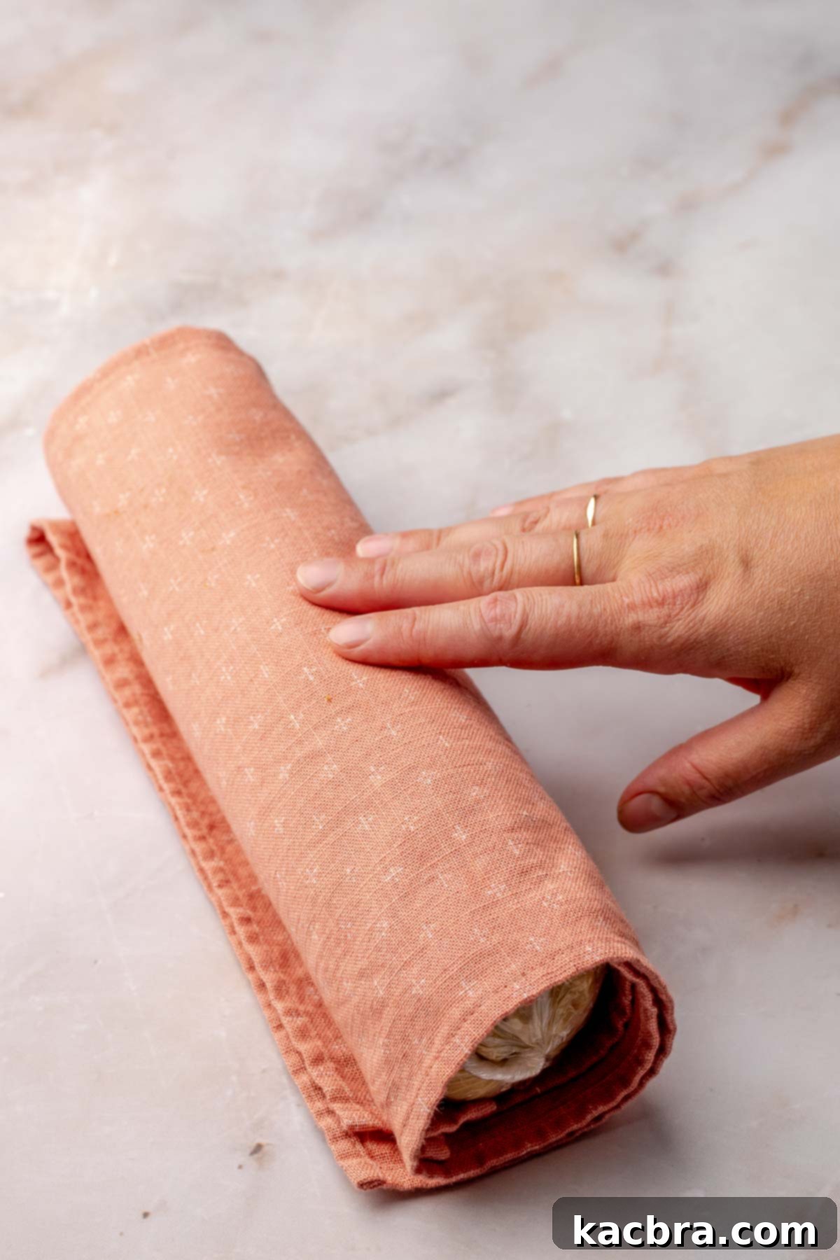 Dough log rolled in a dish towel, ready for chilling in the refrigerator.