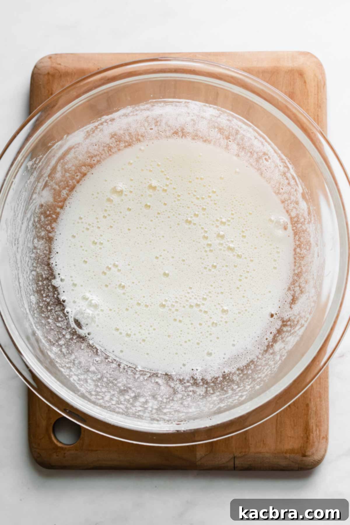 Zesty Meringue Cloud Donuts 11 Heated and whisked egg whites and sugar in a bowl.