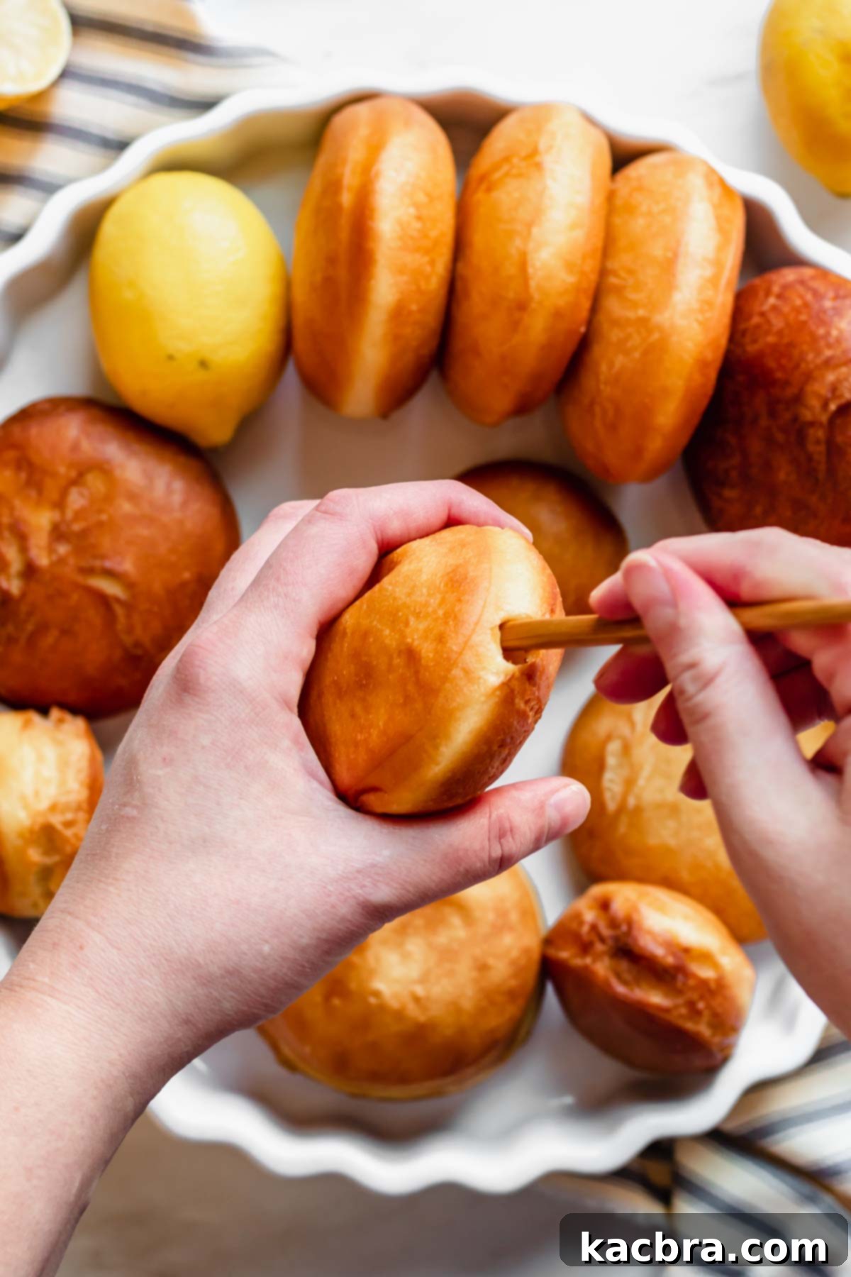 Zesty Meringue Cloud Donuts 13 A chopstick gets inserted into the donut to create an opening for the lemon filling.