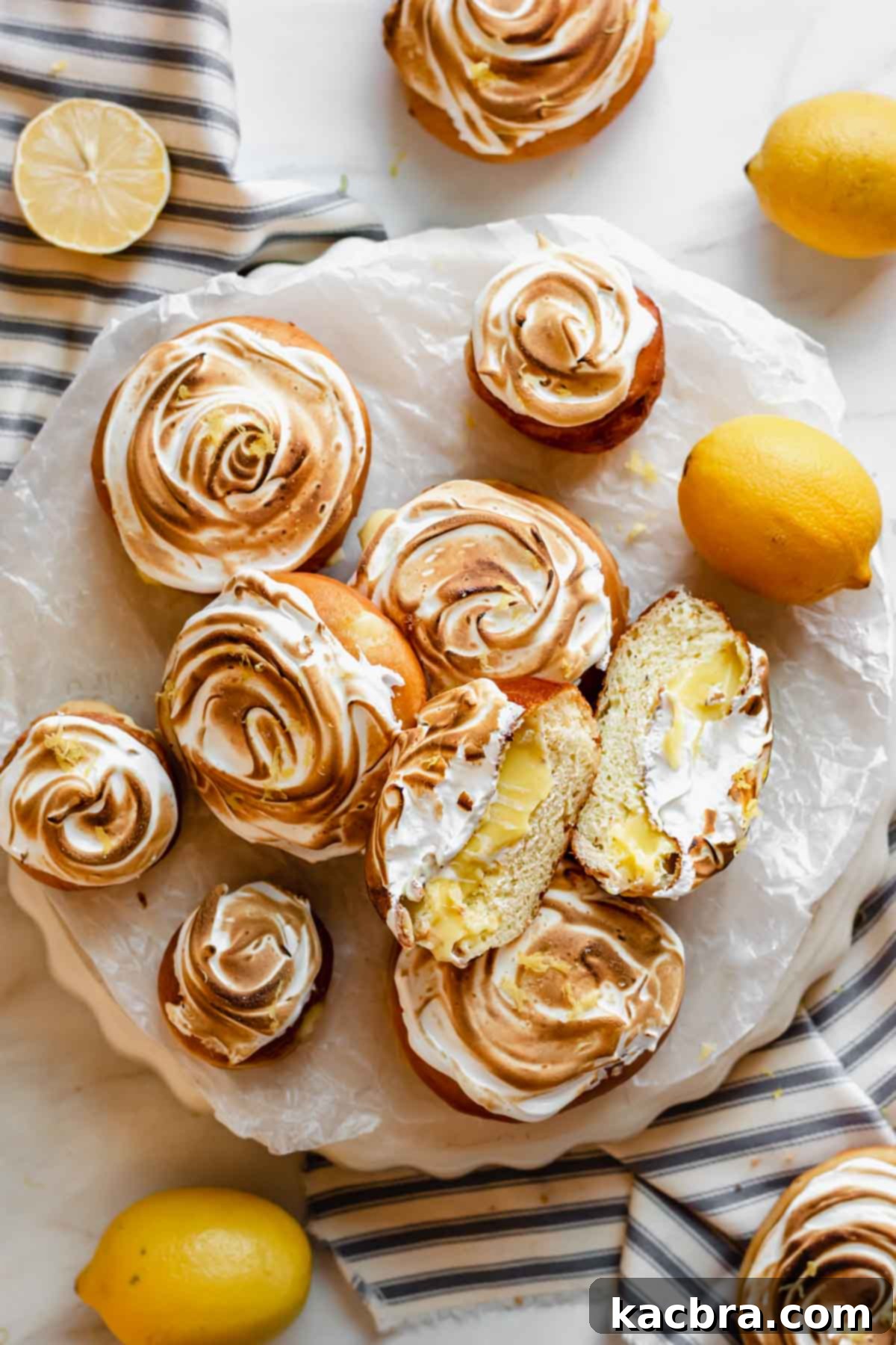 Zesty Meringue Cloud Donuts 16 An array of lemon filled donuts, some normal and some mini.