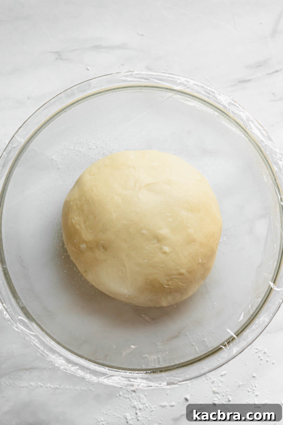 Zesty Meringue Cloud Donuts 6 Dough is added to a bowl after kneading and reading to start the first rise.