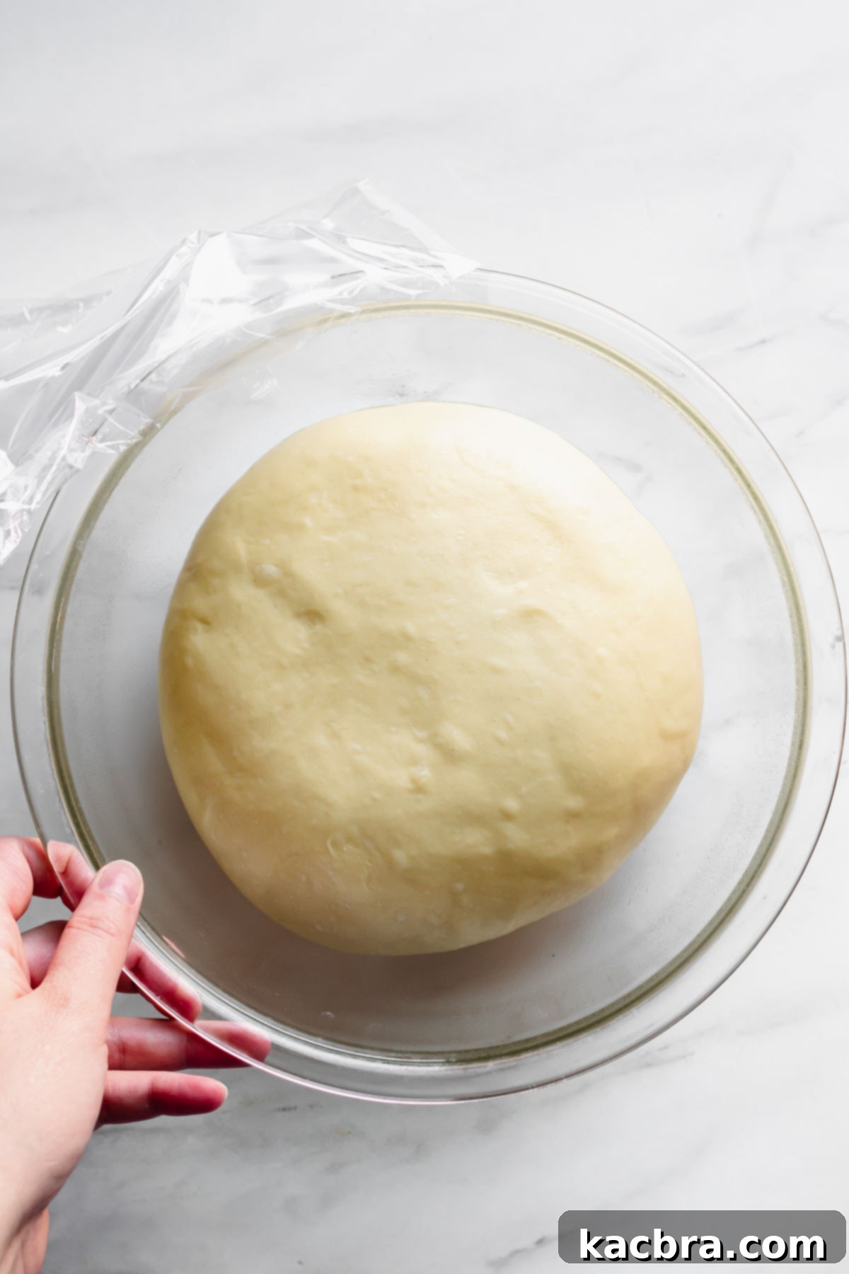 Zesty Meringue Cloud Donuts 7 Donut dough in the bowl has doubled in size and is ready to roll out.