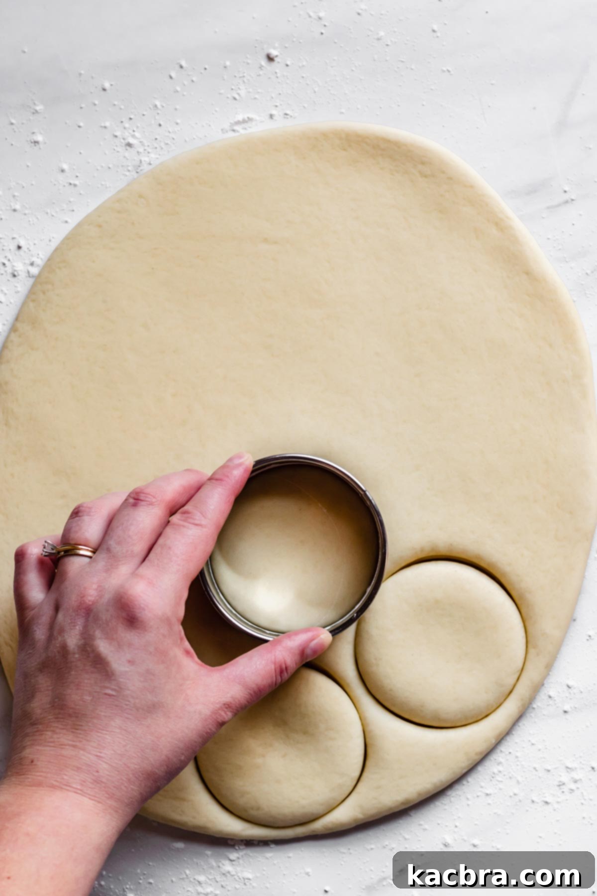 Zesty Meringue Cloud Donuts 8 A cookie cutter is used to stamp out donuts from the rolled out dough.