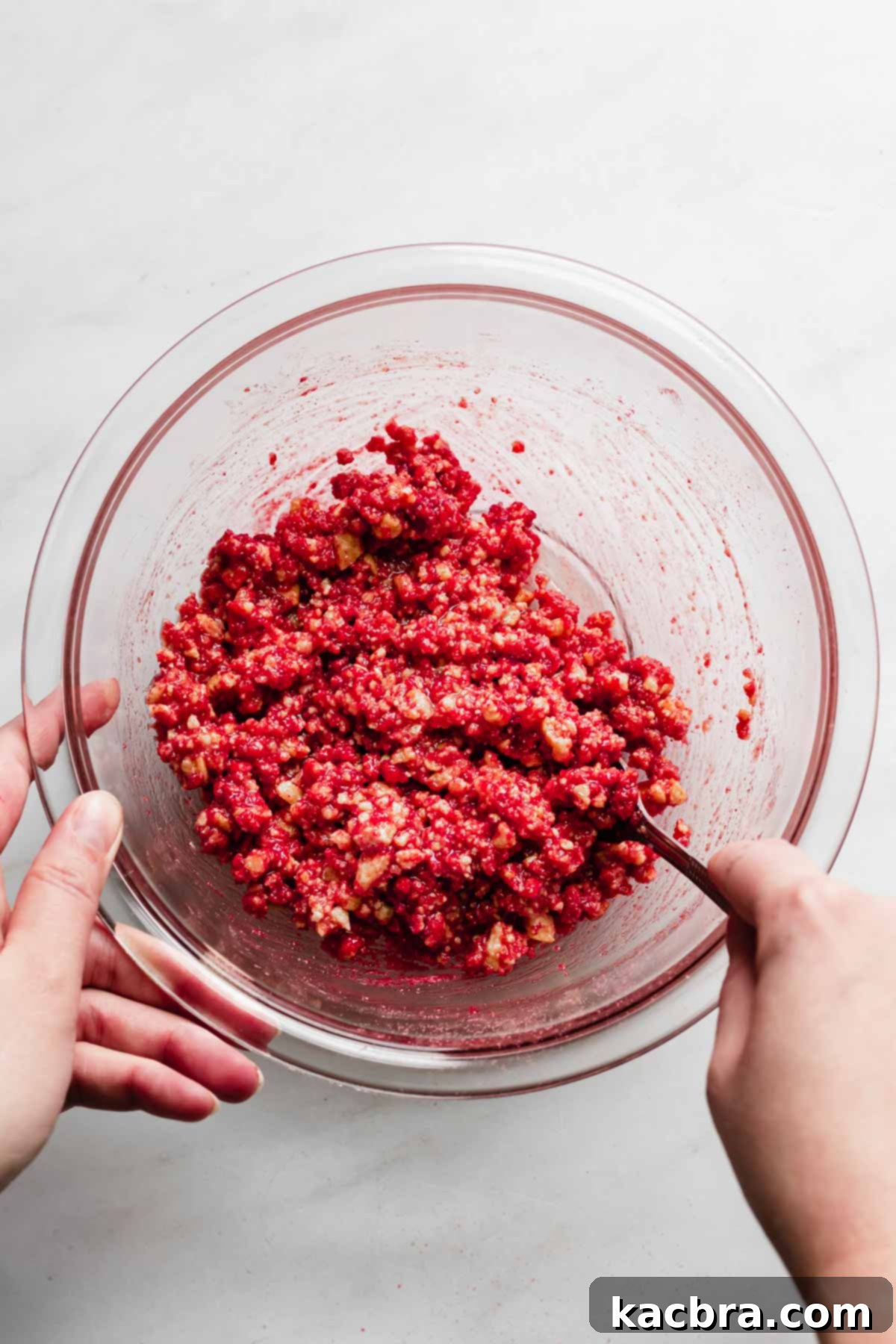 Double Strawberry Crunch Cupcakes 13 The strawberry crunch topping being mixed thoroughly with a fork, ensuring all ingredients are evenly combined to form a perfect crumble.