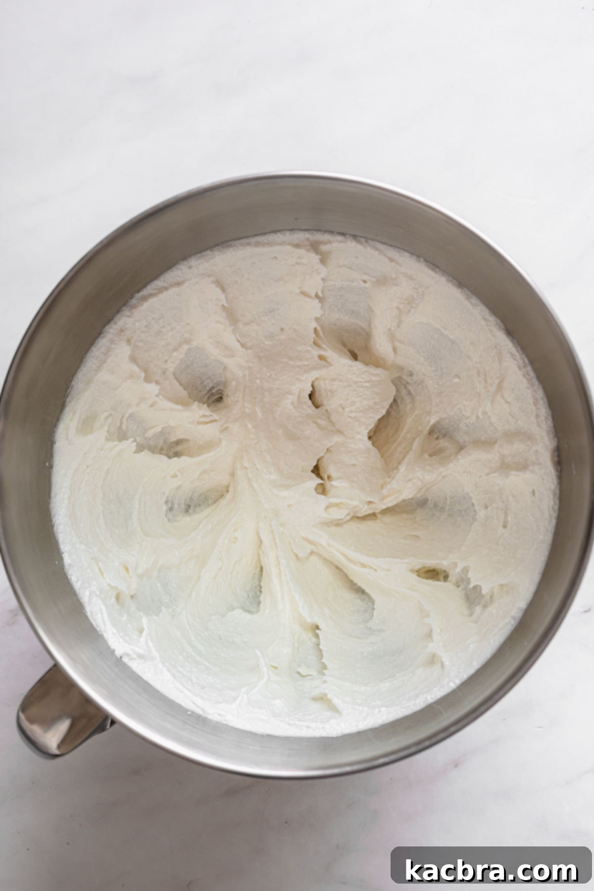 Double Strawberry Crunch Cupcakes 4 The initial ingredients of butter, oil, and sugar being creamed together in a stand mixer bowl until light and fluffy.