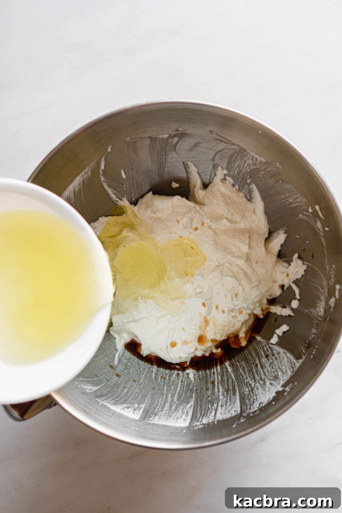 Double Strawberry Crunch Cupcakes 5 Room temperature egg whites are carefully added to the creamed butter and sugar mixture, ready for further beating.