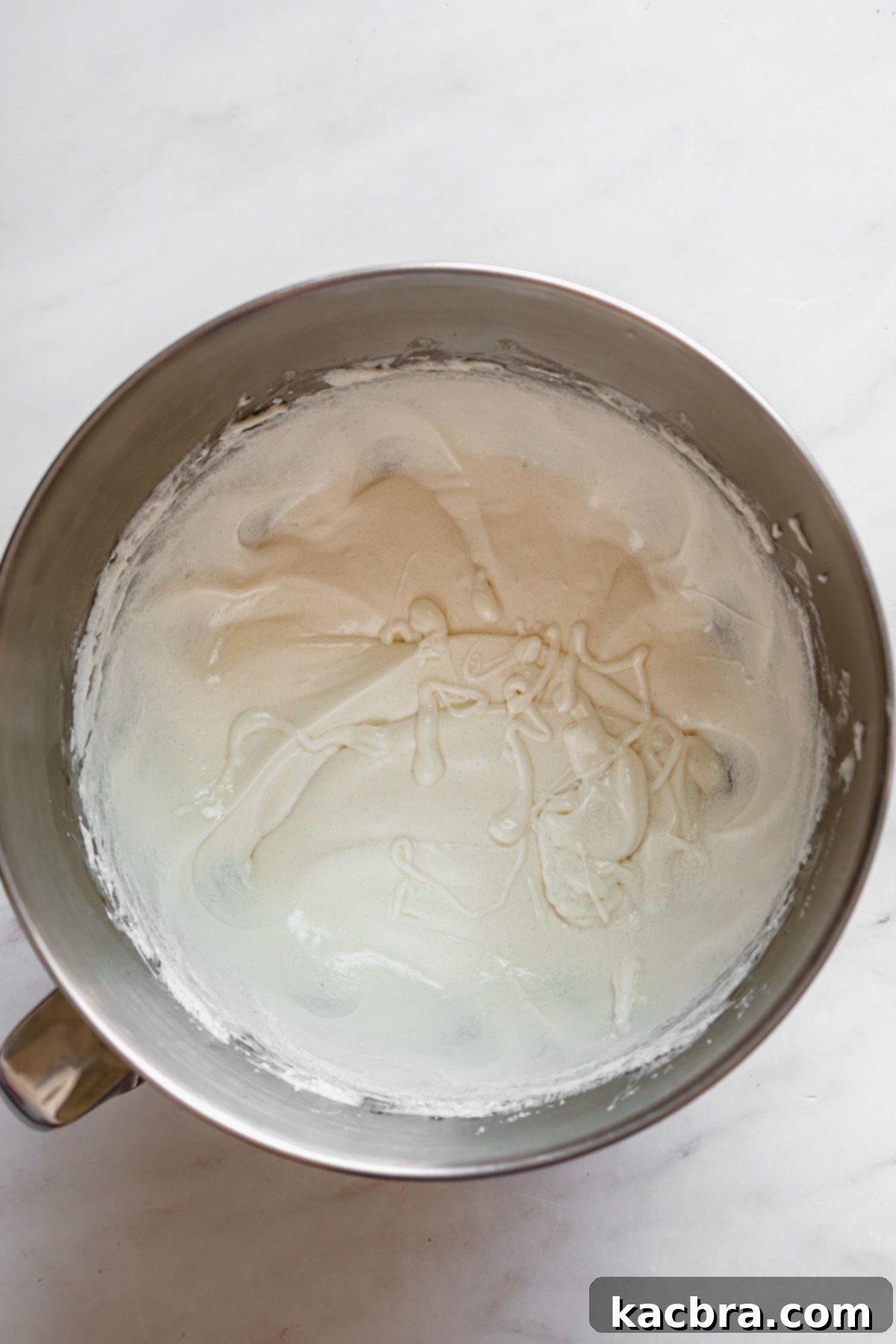 Double Strawberry Crunch Cupcakes 6 The cupcake batter, now visibly thickening and becoming airy after the addition of egg whites and vanilla, showing a smooth consistency.