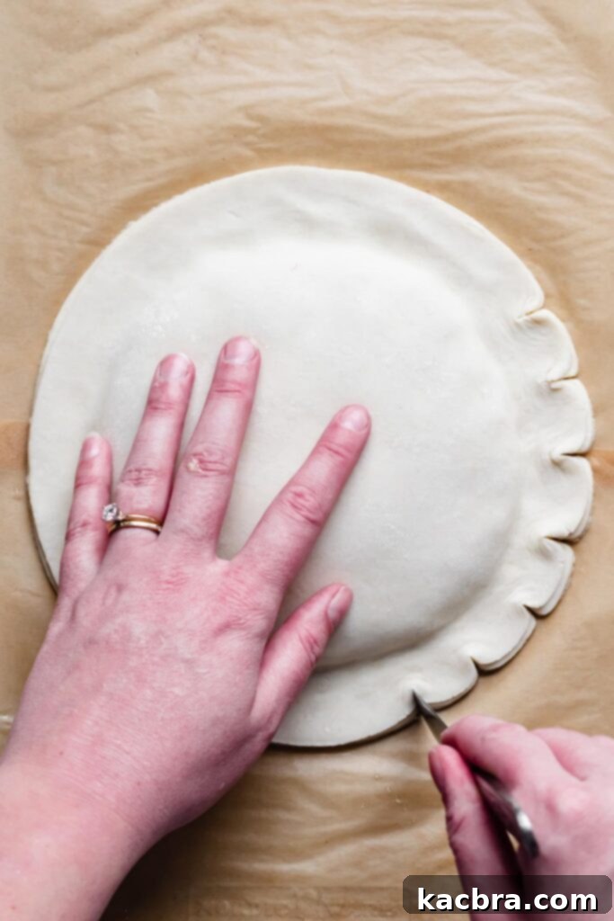 A butter knife creates attractive decorative indents along the side of the assembled pastry.