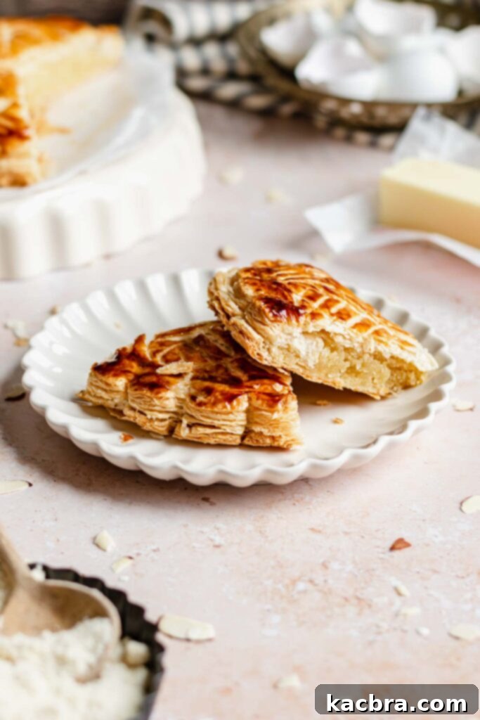 Two enticing slices of Galette des Rois beautifully arranged on a white plate.