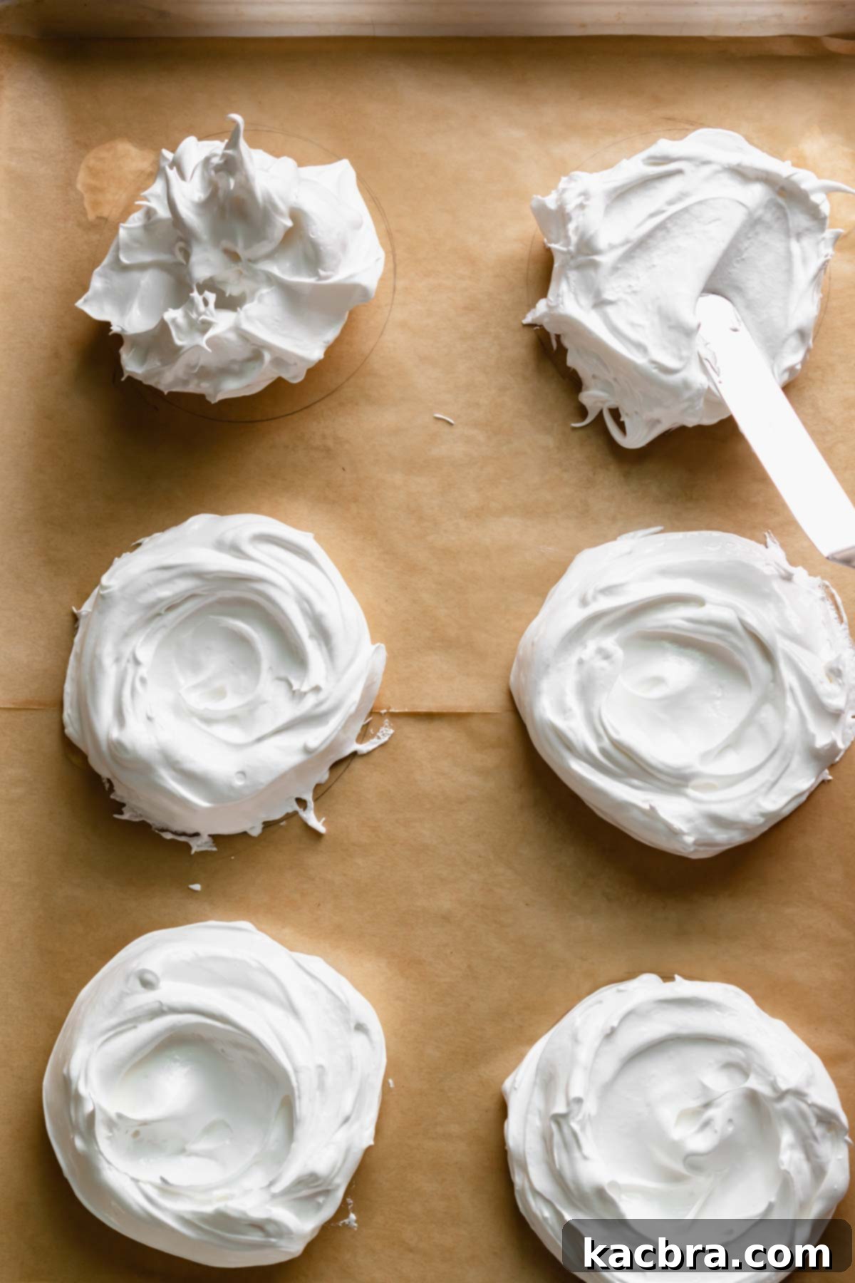 Crisp Meringue Nests with Bright Grapefruit Curd 12 An offset spatula delicately shapes the meringue into a perfect nest, gently pushing it into a circular form and creating a graceful swoop in the center, ready for filling.