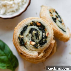 A stack of golden-brown spinach and feta pinwheels, ready to be served.