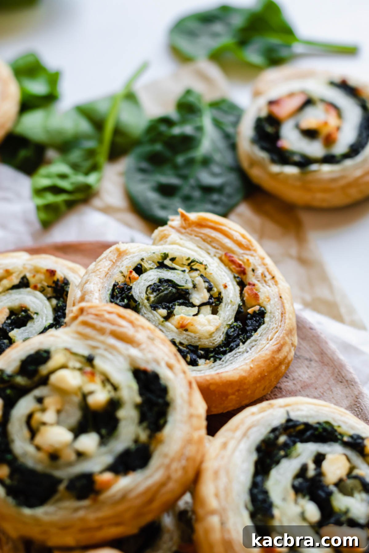 A beautifully arranged plate featuring freshly baked spinach and feta pinwheels, ready for serving.