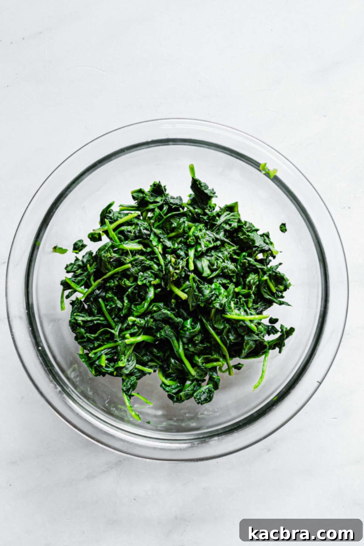 Roughly chopped spinach in a bowl after being squeezed dry.