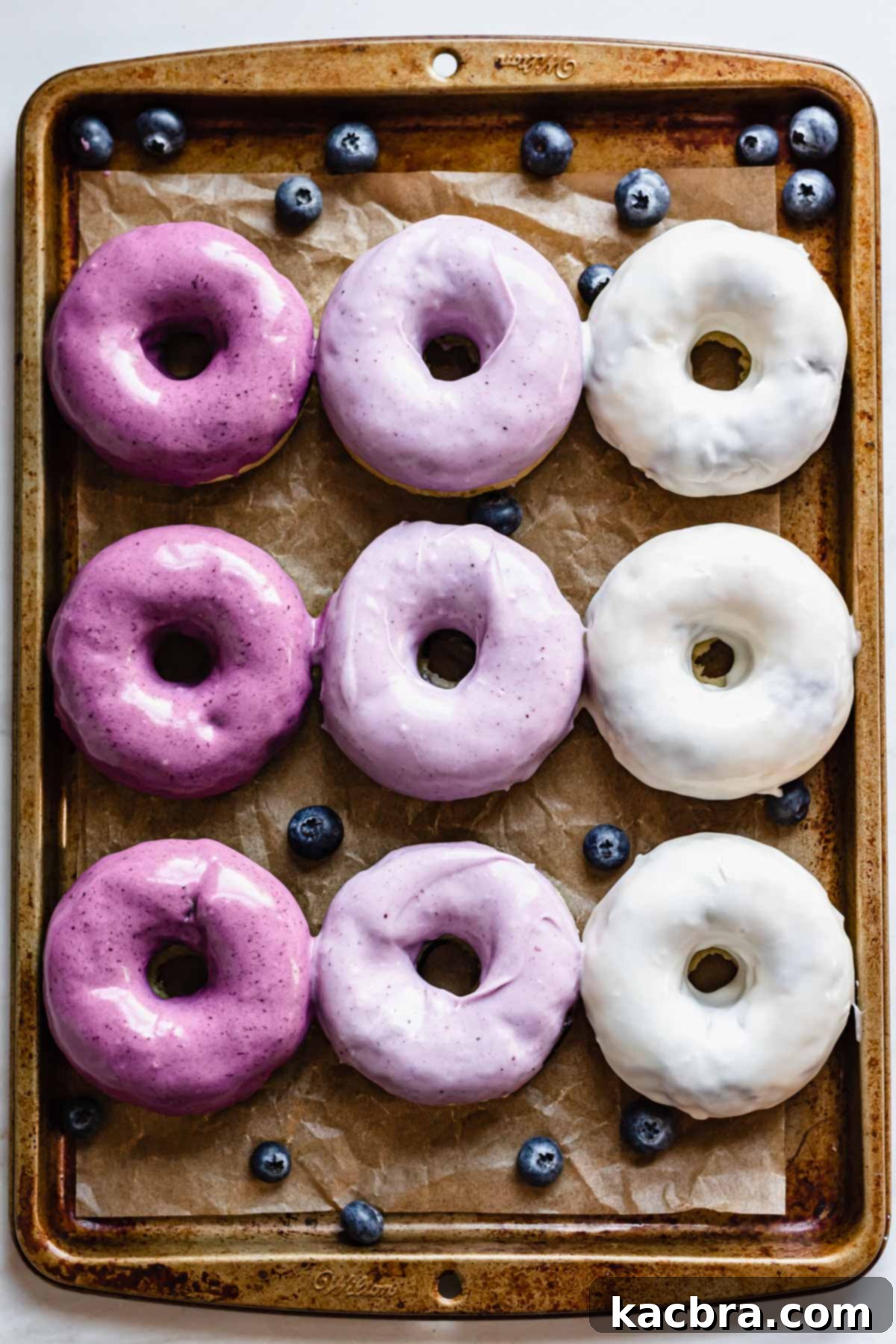 Oven-Fresh Blueberry Glazed Rounds 12 Pan of ombre blueberry glazed donuts.