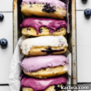Oven-Fresh Blueberry Glazed Rounds 14 Glazed blueberry donuts lined up in a pan.
