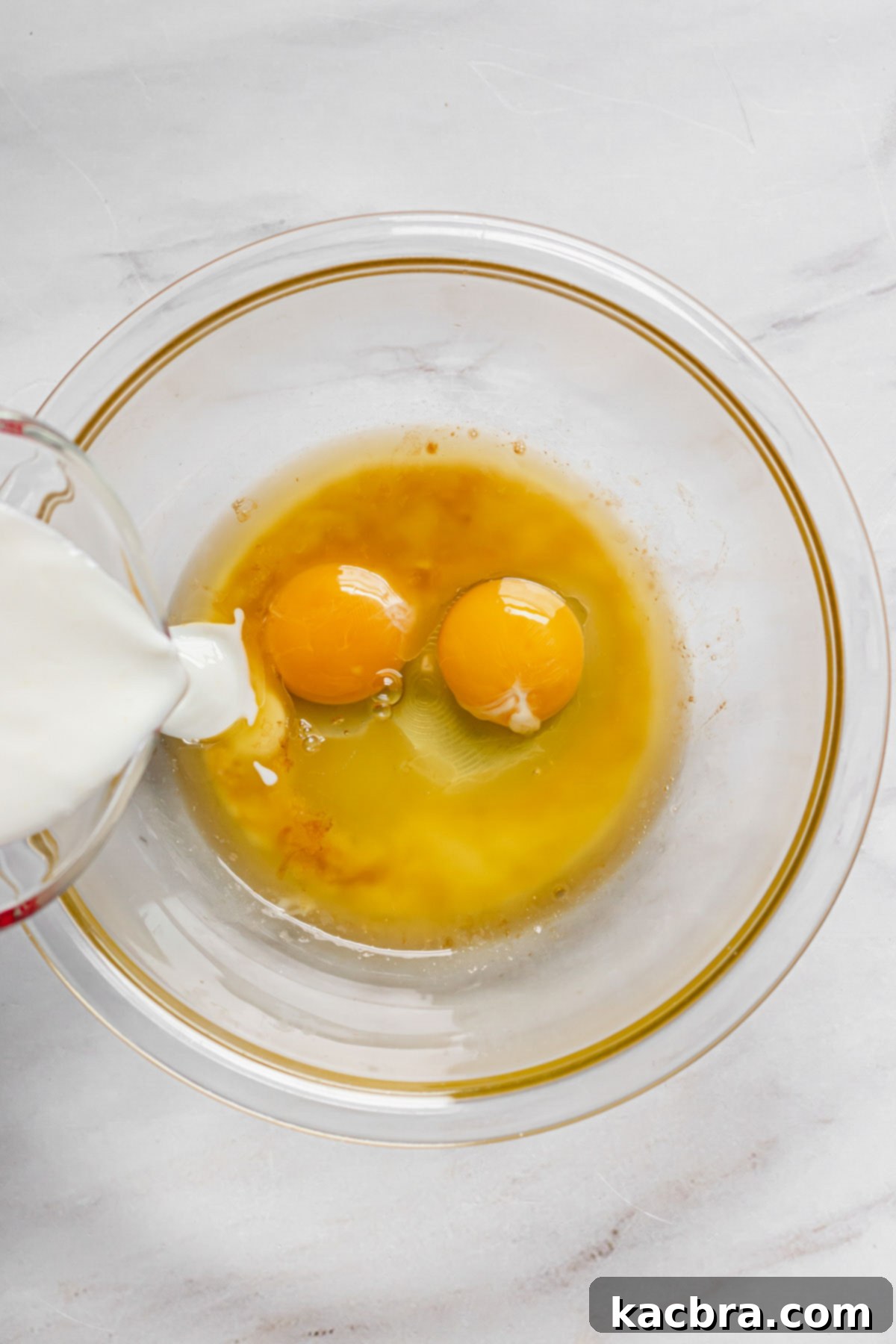 Oven-Fresh Blueberry Glazed Rounds 4 Buttermilk being added to the eggs.