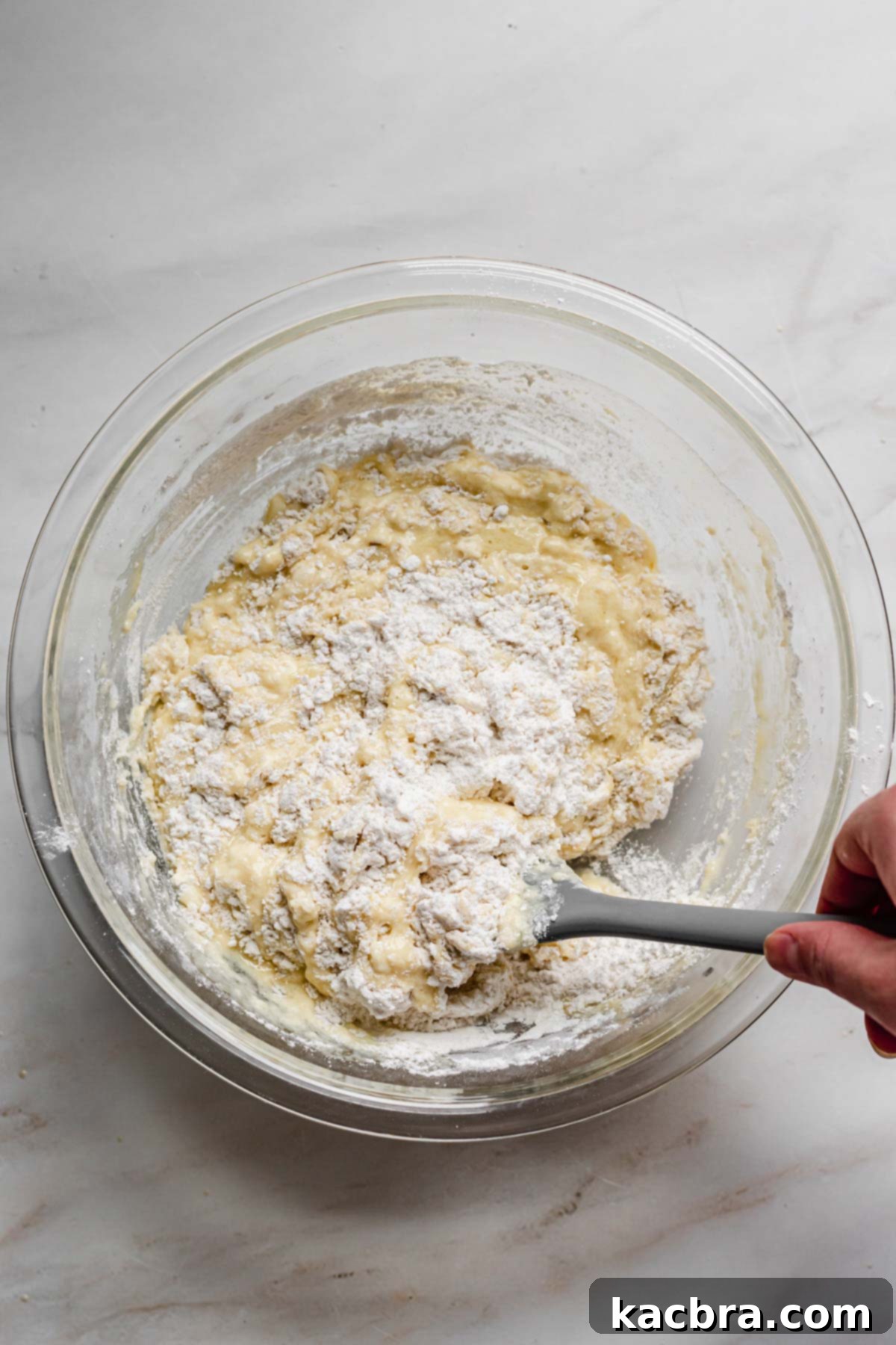 Oven-Fresh Blueberry Glazed Rounds 6 Folding the batter with a rubber spatula.