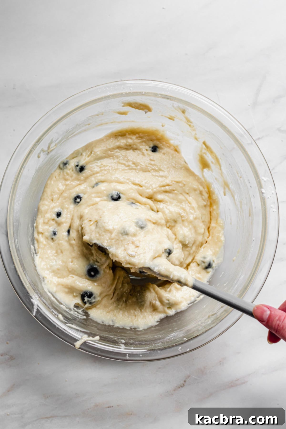Oven-Fresh Blueberry Glazed Rounds 7 Folding in the blueberries into the batter.