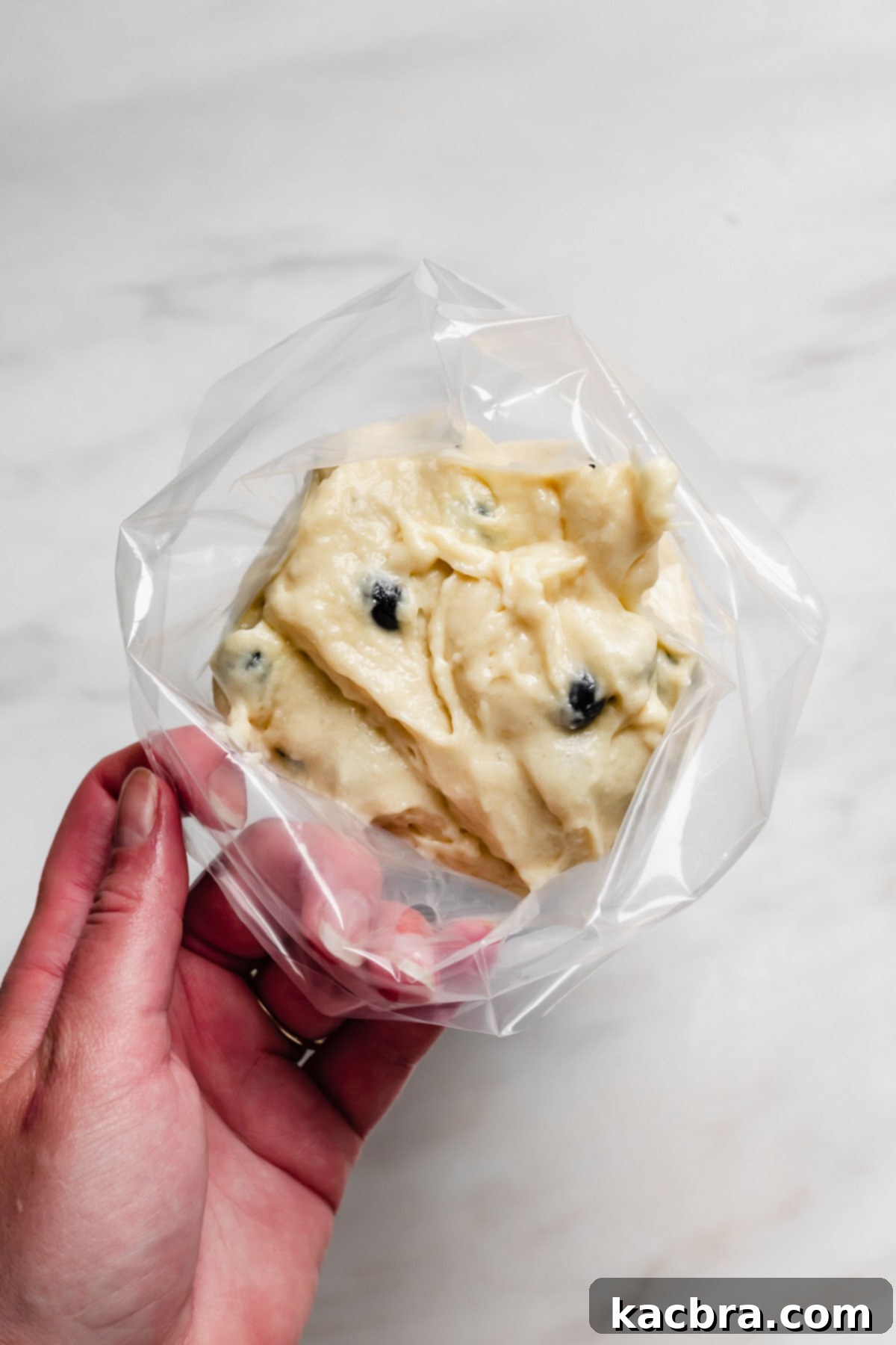 Oven-Fresh Blueberry Glazed Rounds 8 Batter in a piping bag.