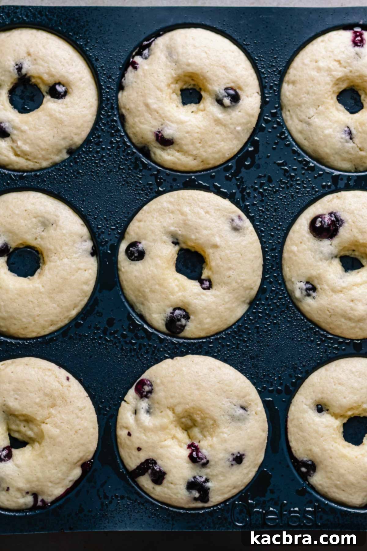 Oven-Fresh Blueberry Glazed Rounds 10 Baked donuts in a donut pan.