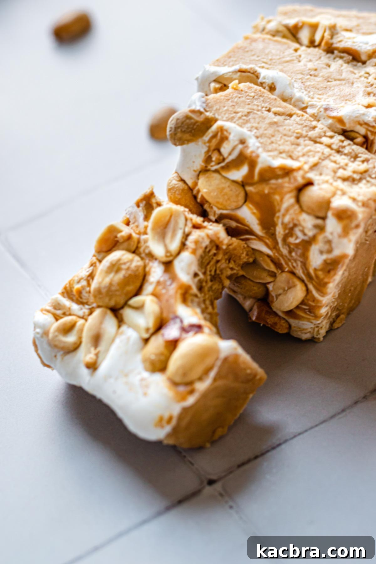 Decadent Fluffernutter Fudge 3 Several perfectly cut squares of fluffernutter fudge, showcasing the distinct layers of peanut butter fudge and marshmallow swirl.