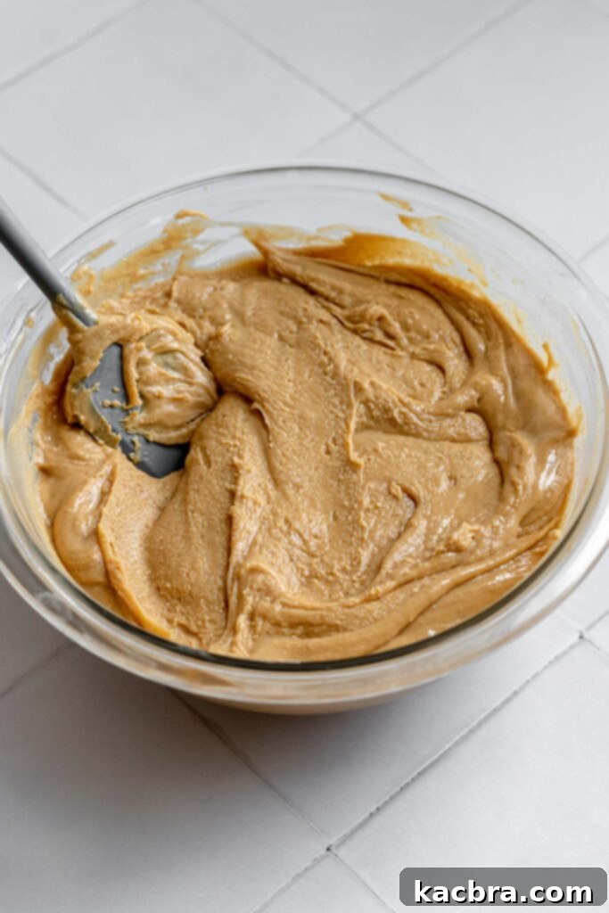 Decadent Fluffernutter Fudge 8 The fudge mixture visibly thickening in the bowl as it is stirred, reaching the desired consistency.