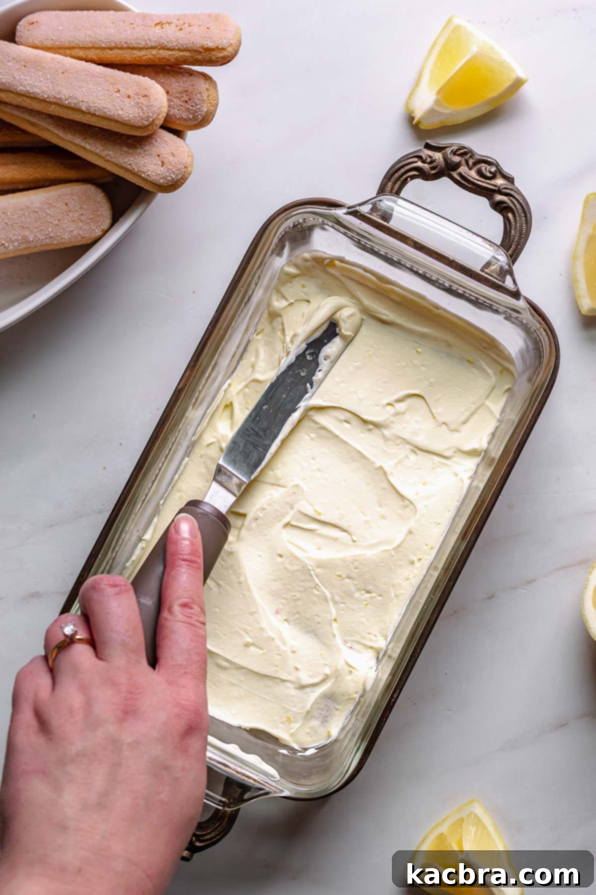 Spreading on the first half of the lemon mascarpone cream over the ladyfingers.