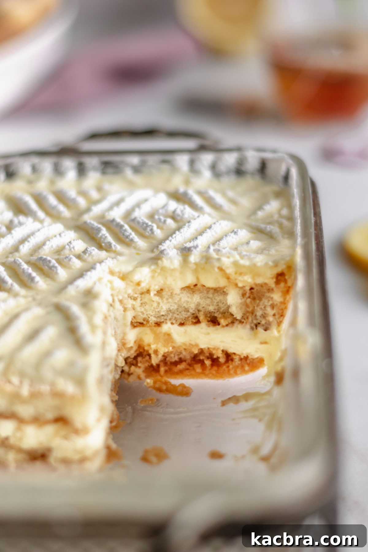 Pan of Earl Grey Tiramisu with a slice removed, showing off the perfectly set layers.