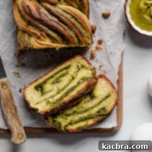 Pistachio babka loaf with two slices next to it.