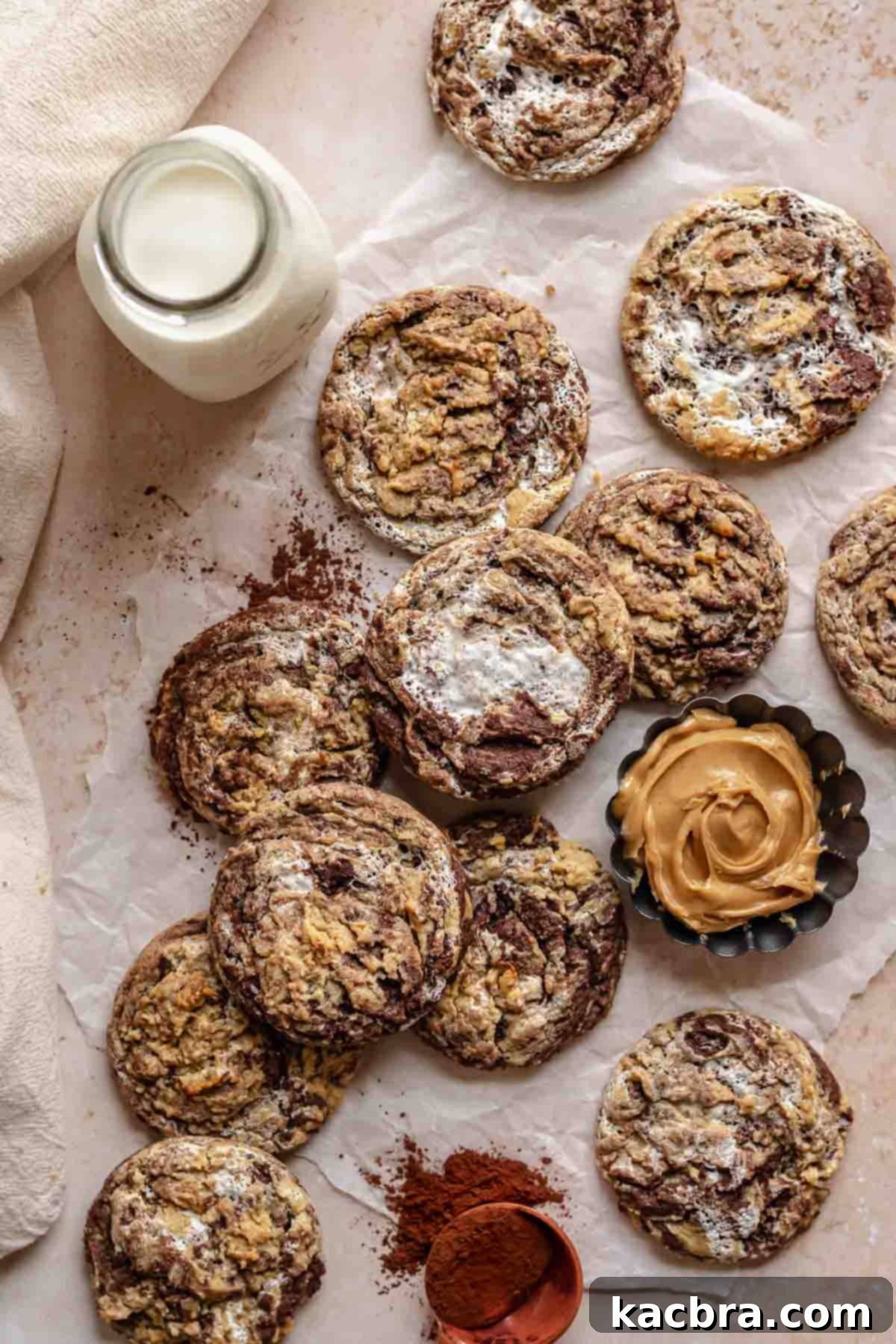 Gooey Peanut Butter Marshmallow Chocolate Cookies 3 Layers of peanut butter marshmallow chocolate cookies spread across a table.