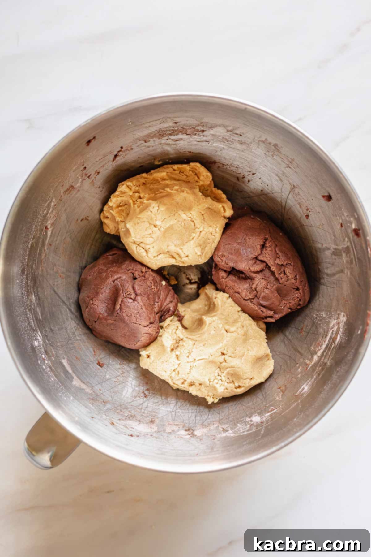 Gooey Peanut Butter Marshmallow Chocolate Cookies 6 Chocolate and peanut butter doughs separated into quarters in a bowl.