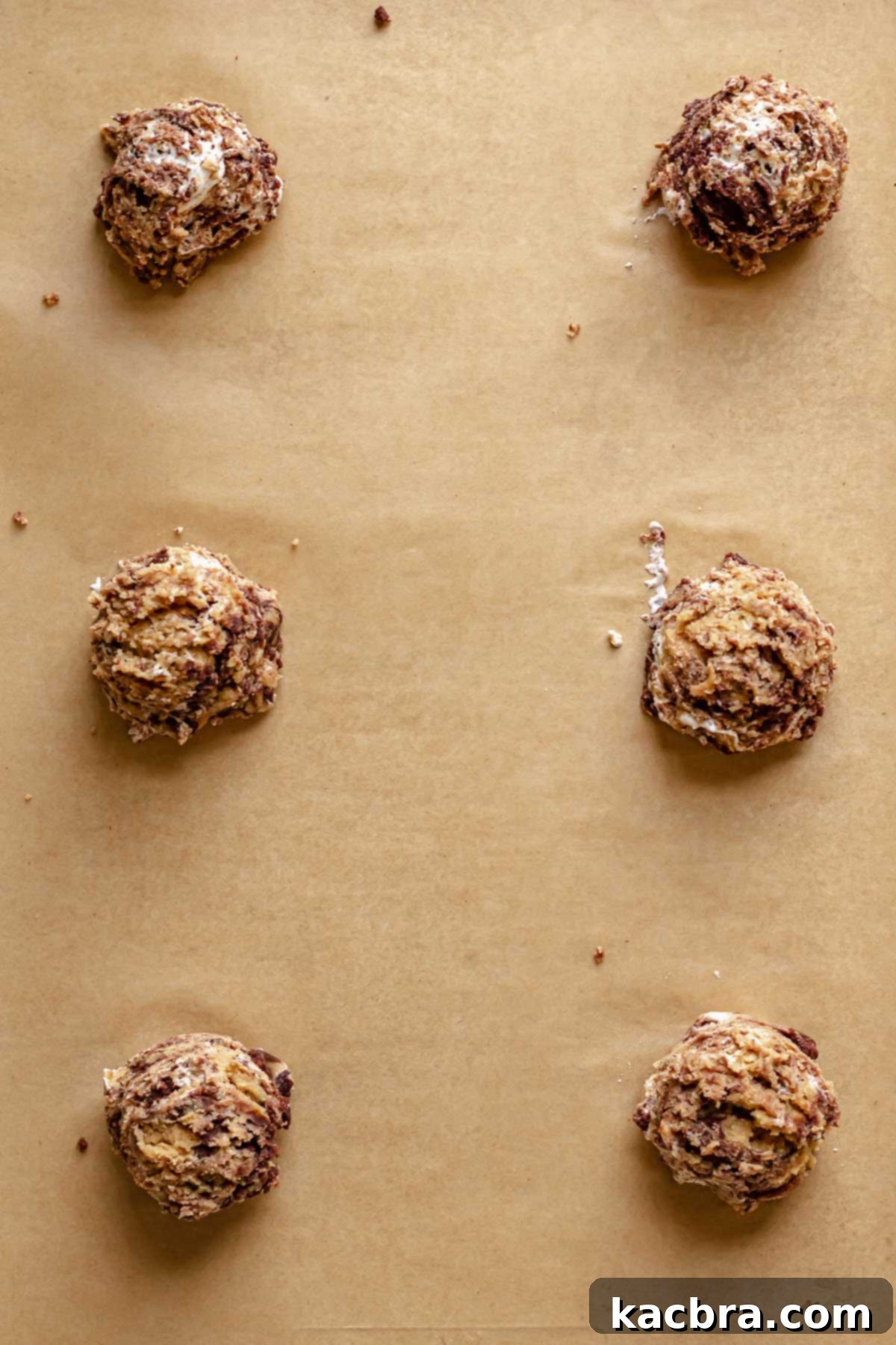 Gooey Peanut Butter Marshmallow Chocolate Cookies 8 Scooped peanut butter marshmallow chocolate cookie dough on a cookie sheet.