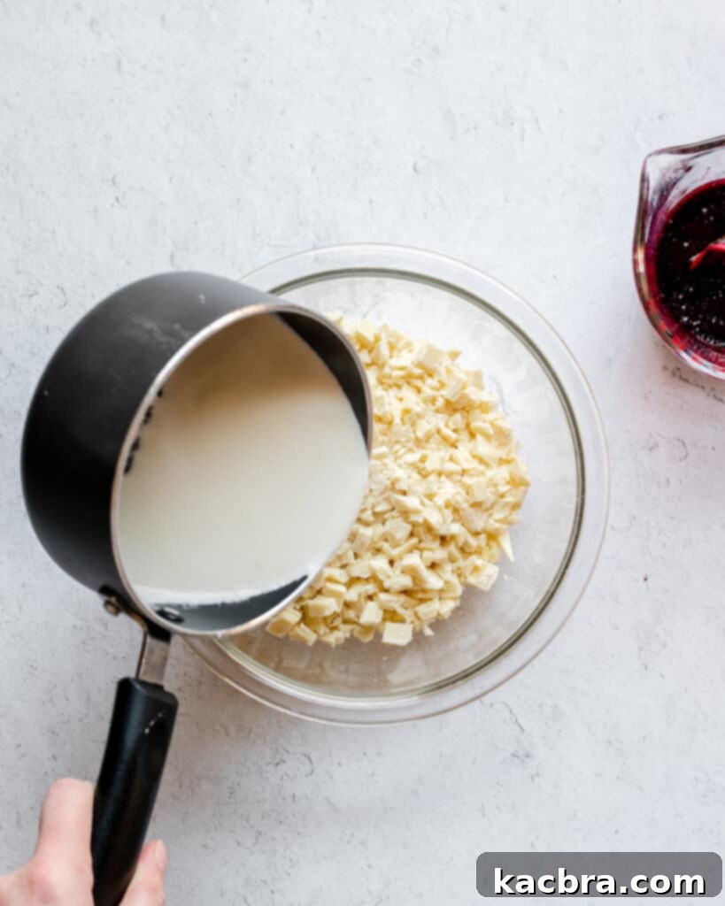 Blueberries being cooked down in a saucepan, mashing them to release juices.