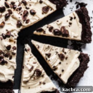 Three slices of chocolate espresso tart are pulled away from the rest of the tart in an overhead shot.