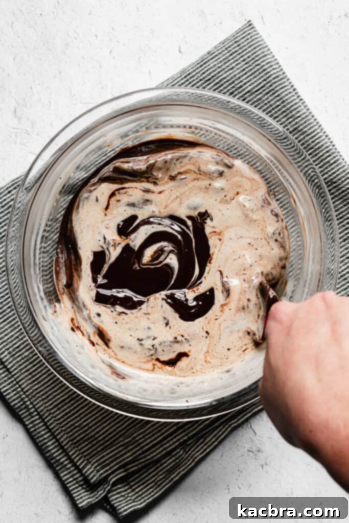 Hot heavy cream being poured over chopped chocolate and espresso.