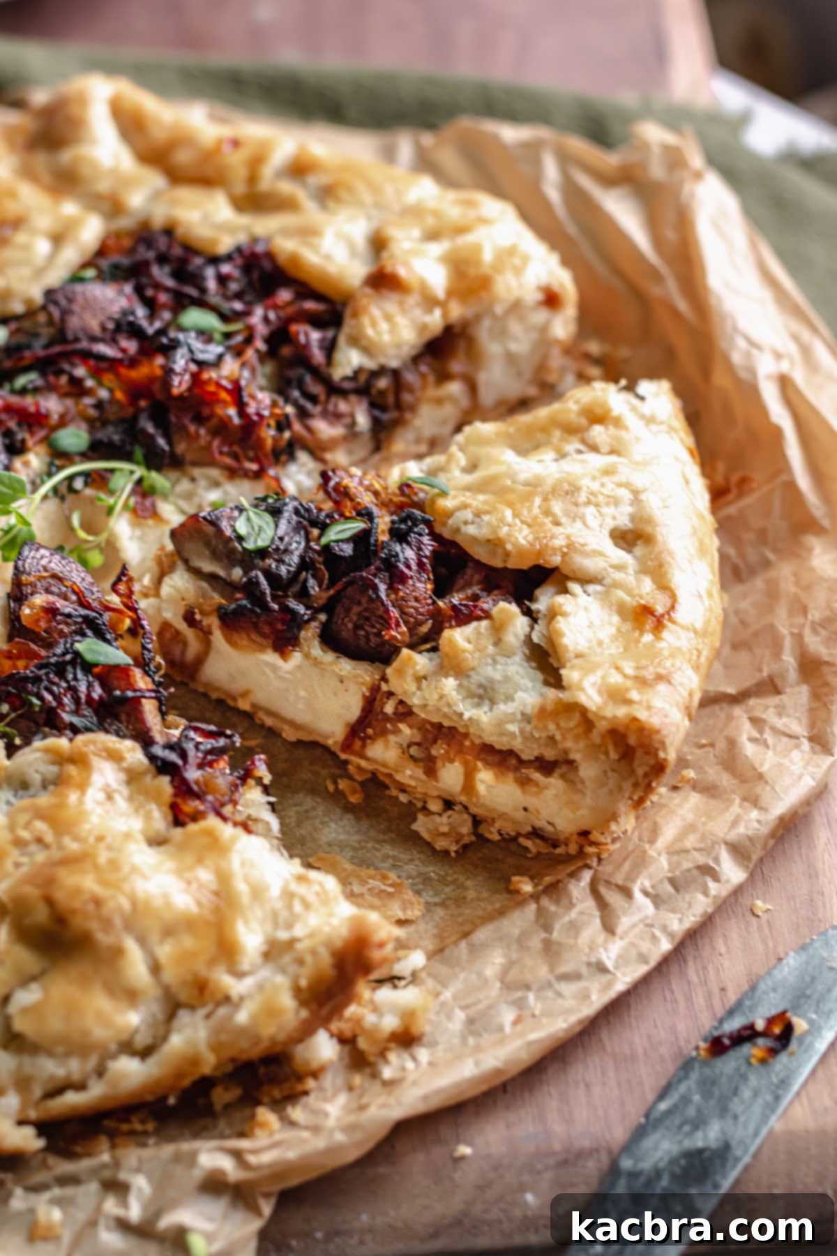 Sweet Caramelized Onion & Mushroom Potato Tart 2 One slice of tart removed and the insides exposed.