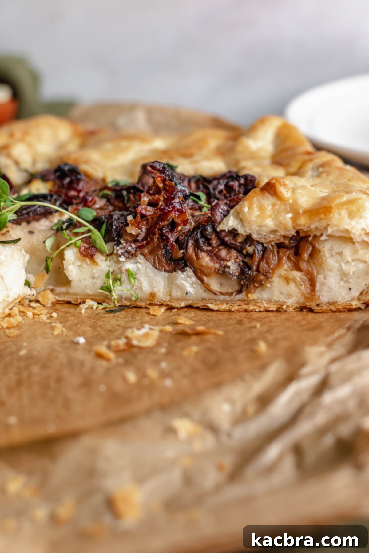 Sweet Caramelized Onion & Mushroom Potato Tart 12 Potato tart with a slice removed to expose the insides.