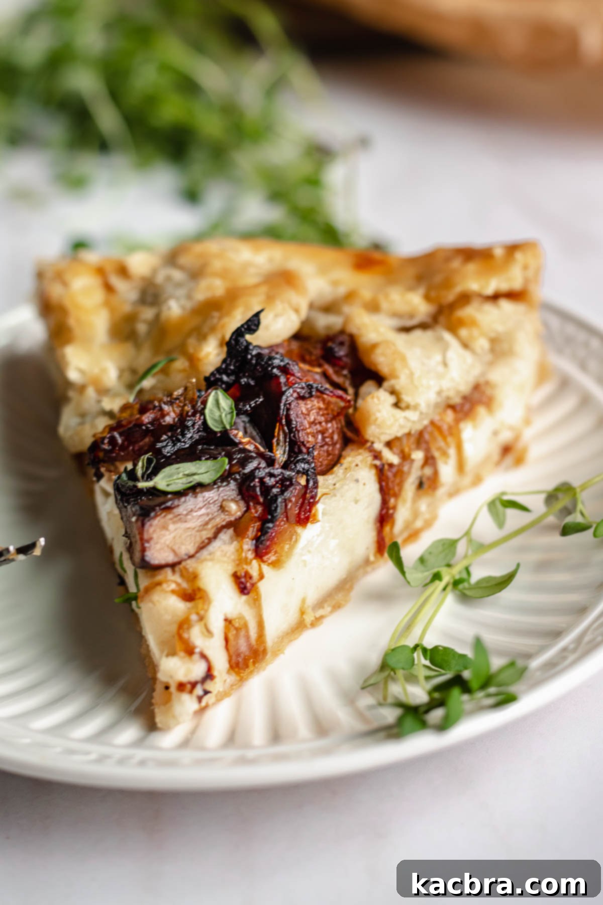 Sweet Caramelized Onion & Mushroom Potato Tart 3 Slice of potato tart on a plate.