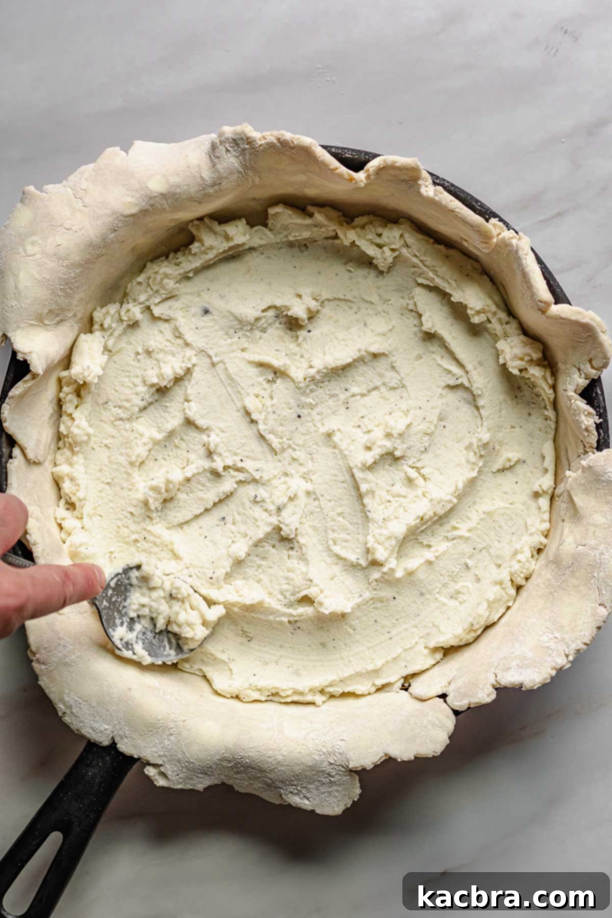 Sweet Caramelized Onion & Mushroom Potato Tart 6 Mashed potatoes getting spread into the pie crust.