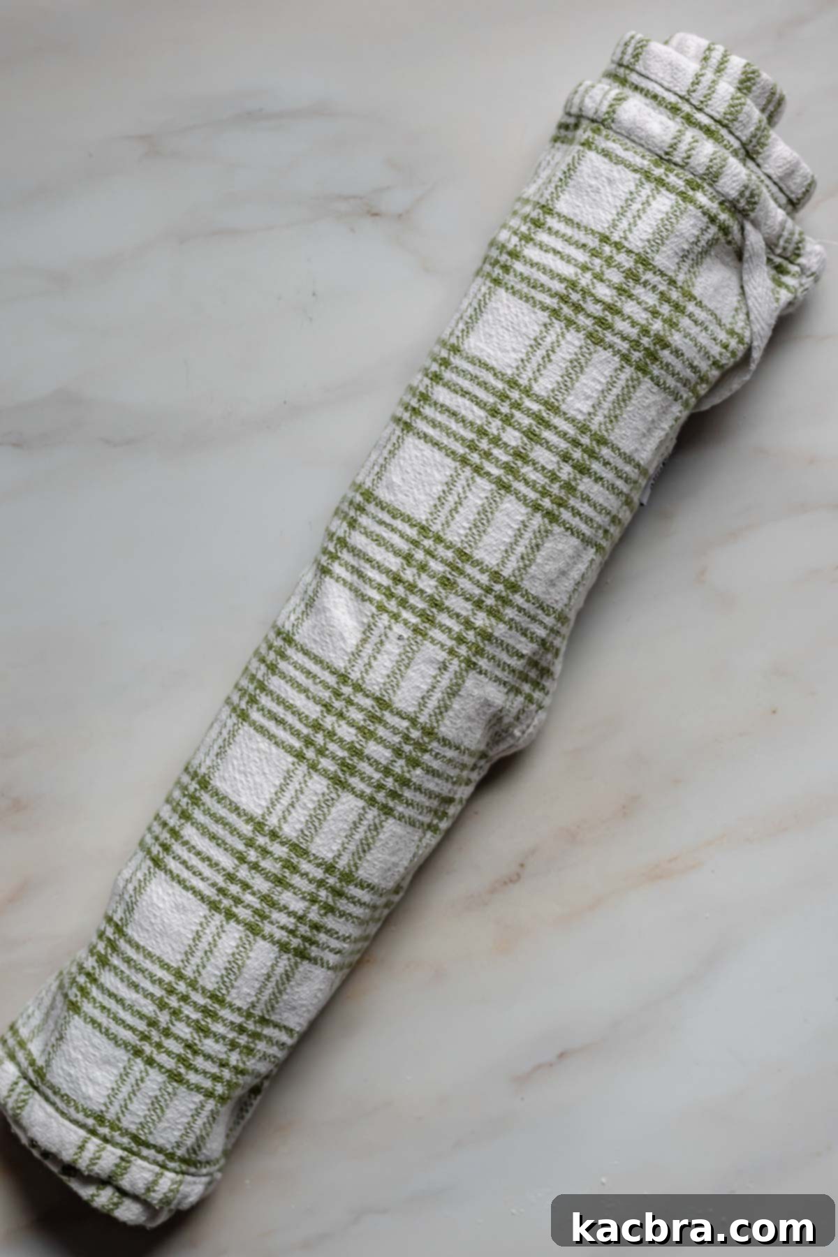 Swiss roll in a kitchen towel.