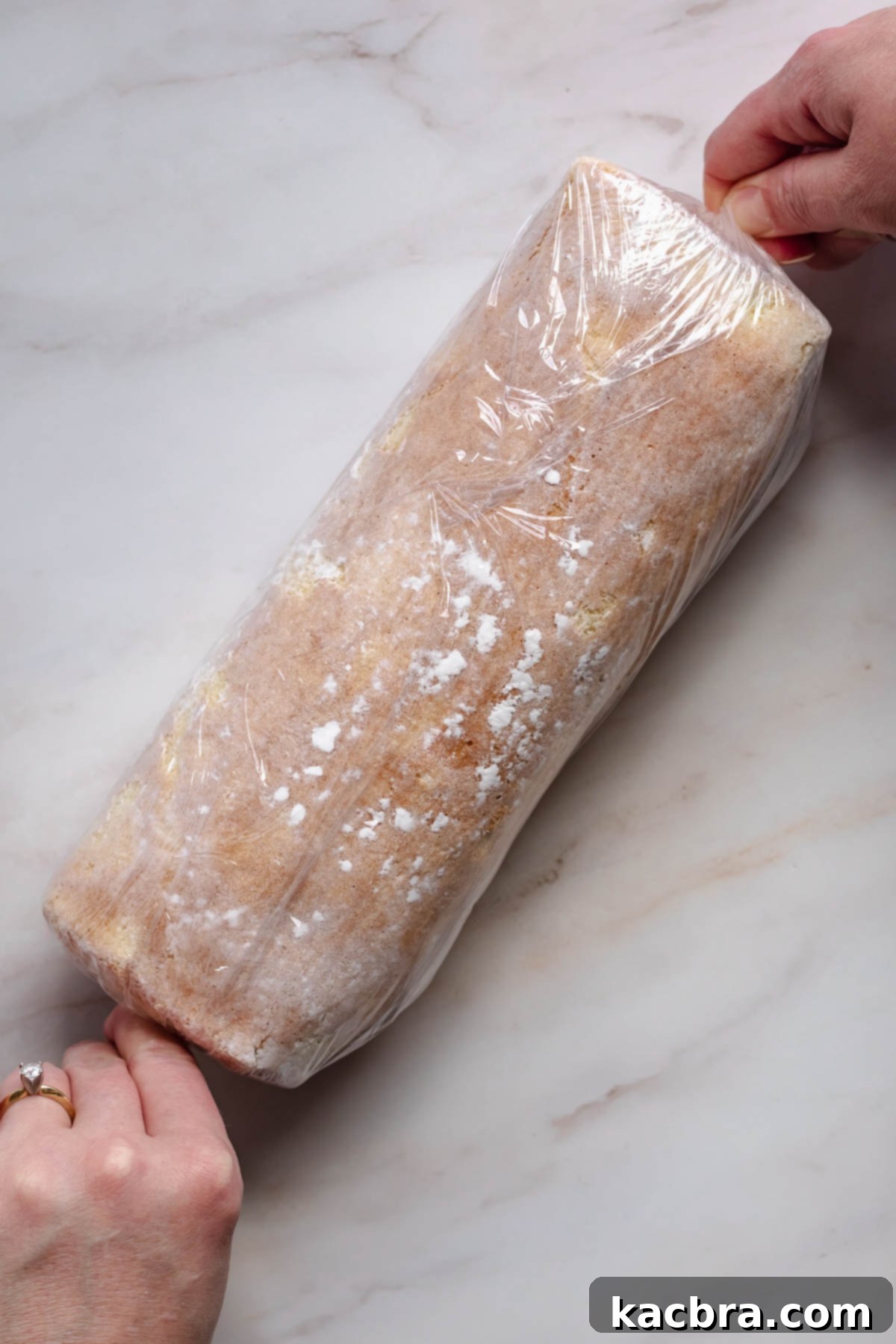 Raspberry and Vanilla Swirl Cake with Decadent Chocolate Ganache 16 Rolled Swiss roll in plastic wrap.