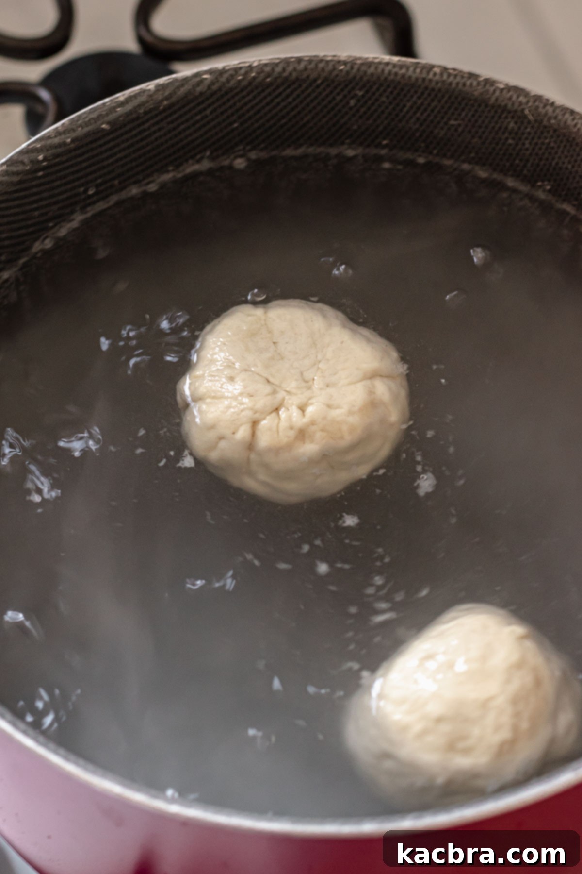 Savory Pimento Pretzel Twists 12 Pretzel buns floating in simmering water during the baking soda bath.